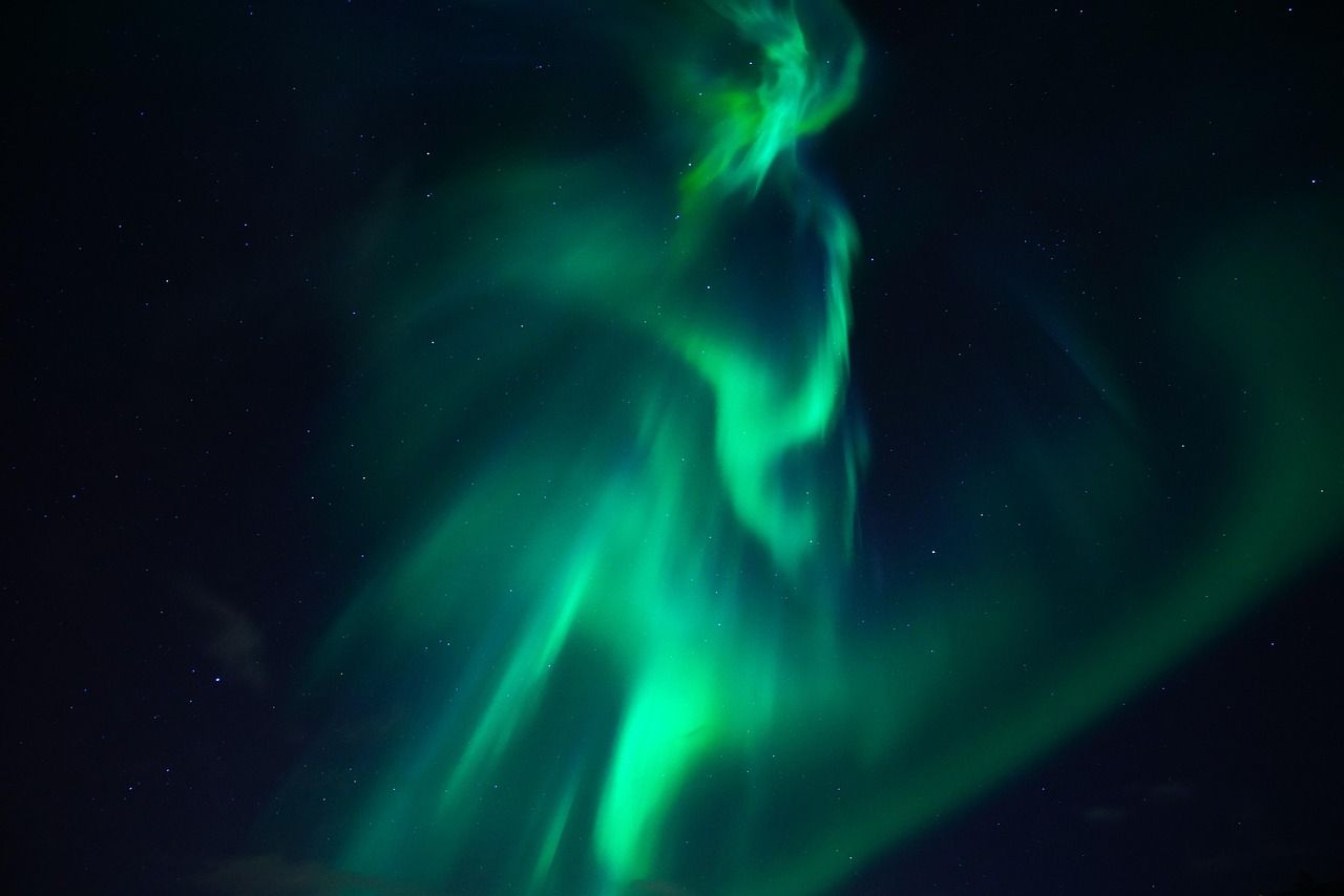 Aurora display over the Icelandic countryside seen on a multi-day tour