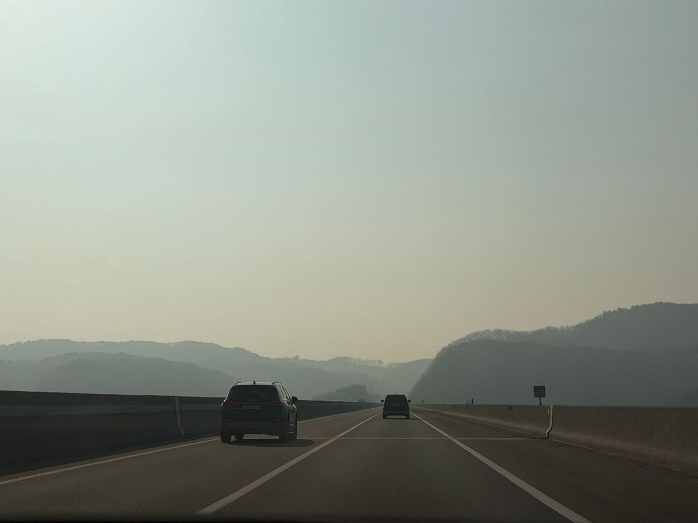 Car on Route 1 with mountains and coastline in the distance
