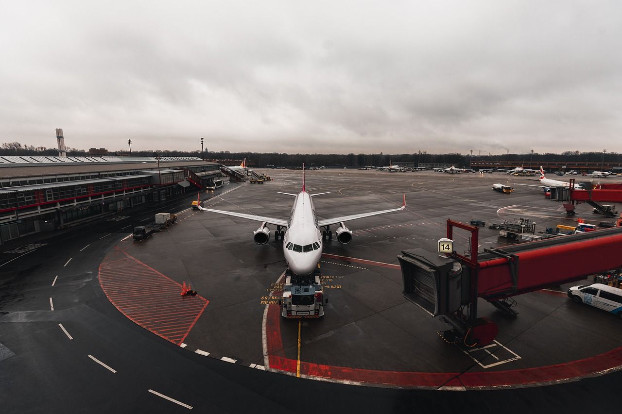 Coach loading passengers and luggage outside Keflavik airport terminal