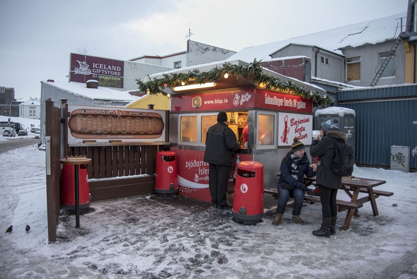 The Bæjarins Beztu Pylsur hot dog stand in Reykjavik in the snow, with people queuing